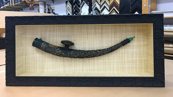A Cambodian opium pipe carved from a water buffalo horn.