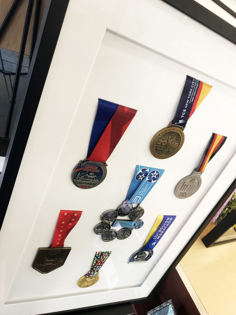 A shadowbox collection of marathon medals from around the world.